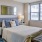 Spacious and well lit bedroom with plush carpet and large windows