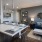Spacious and well lit kitchen with wood floors and stainless steel appliances. 