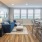 Spacious and well lit living room with wood floors and an open floor plan with access to the kitchen.
