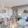 Spacious and well lit living room with wood floors and an open floor plan with access to the kitchen.